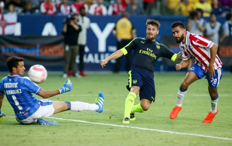 Arsenal's Mathieu Debuchy (C) kicks the ball past Chivas Guadalajara during their friendly match in Carson, California on July 31, 2016