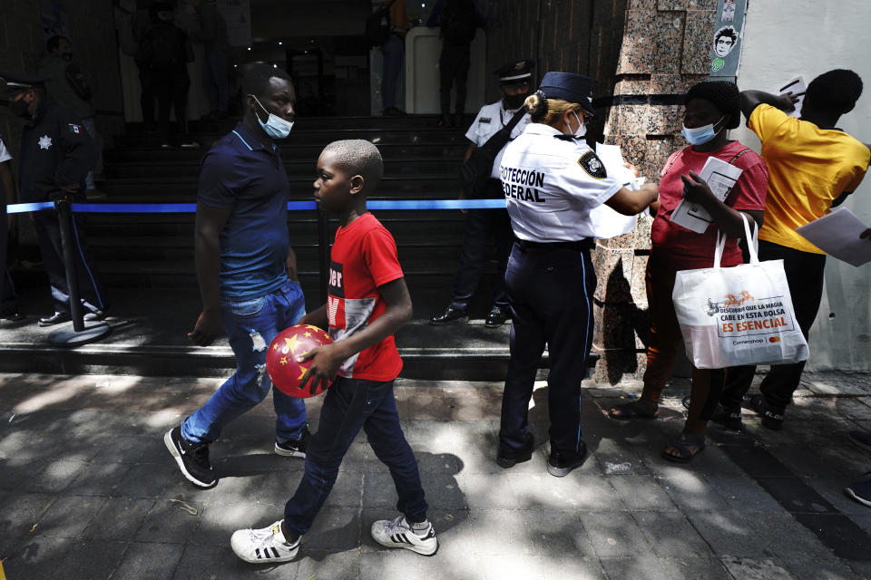 Haitian migrants line up outside the Mexican Commission for Refugee Assistance, COMAR, to request refuge in Mexico City, Wednesday, Sept. 22, 2021. (AP Photo / Marco Ugarte)