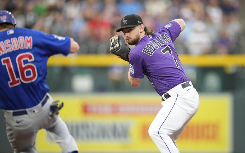 Colorado Rockies second baseman Brendan Rodgers, right, fields the throw to force out Chicago Cubs' Patrick Wisdom at second base on a ground ball hit by Ian Happ in the second inning of a baseball game Tuesday, Aug. 3, 2021, in Denver. (AP Photo/David Zalubowski)