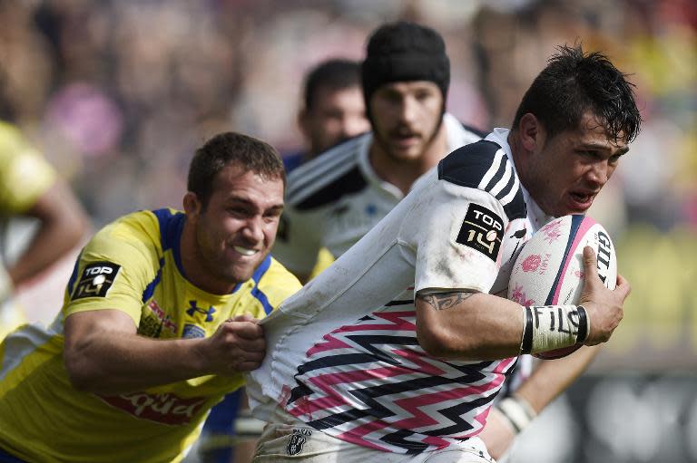 Stade Francais Paris' French flanker Raphael Lakafia (R) tries to escape a tackle by Clermont's French flanker Alexandre Lapandry (L) during the French Top 14 rugby match at Jean Bouin stadium in Paris on March 28, 2015