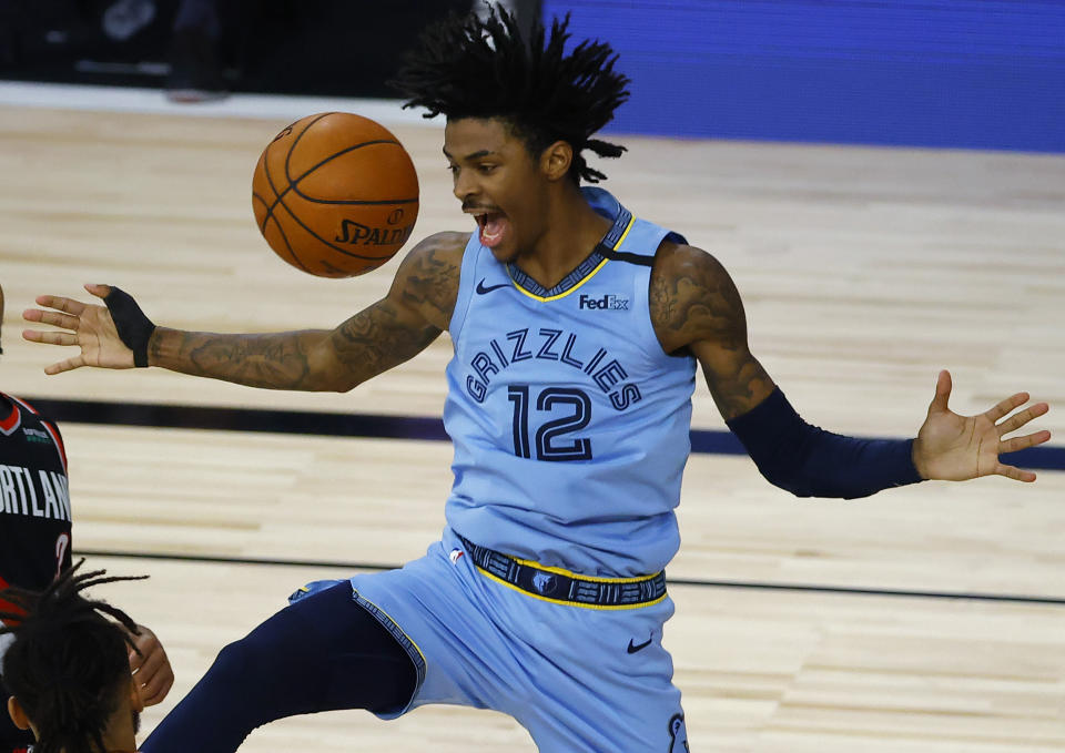 Memphis Grizzlies' Ja Morant reacts after a dunk against the Portland Trail Blazers during the second half of an NBA basketball game Saturday, Aug. 15, 2020, in Lake Buena Vista, Fla. (Kevin C. Cox/Pool Photo via AP)