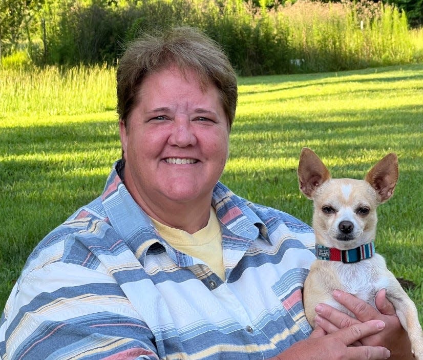 Augusta-area licensed veterinarian Dr. Juli Peters sits with one of her seven dogs in this undated photo. Peters will represent CodaPet, a company specializing in peaceful in-home pet euthanasia.