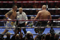 Ukraine's Oleksandr Usyk, left, pursues Britain's Tyson Fury during their undisputed heavyweight world championship boxing fight at the Kingdom Arena in Riyadh, Saudi Arabia, Sunday, May 19, 2024. (AP Photo/Francisco Seco)
