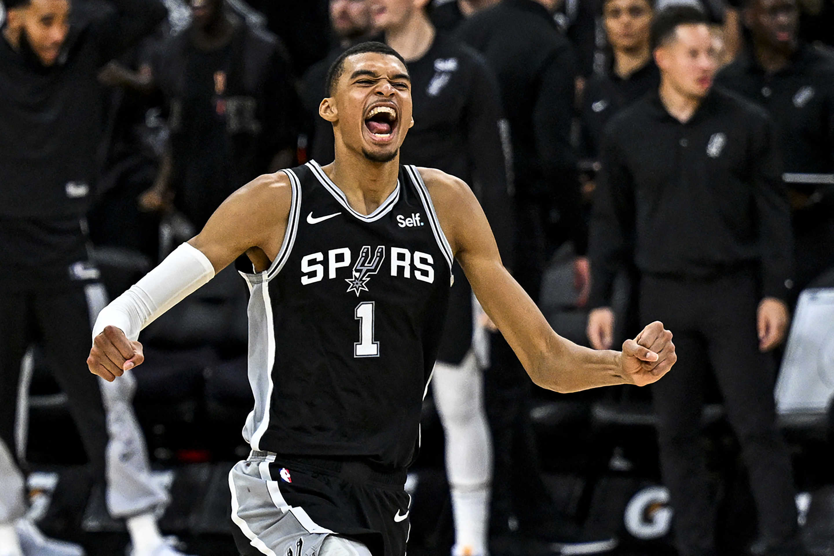 San Antonio Spurs rookie Victor Wembanyama celebrates after beating the Houston Rockets for his first NBA win on Oct. 27, 2023. (Photo by CHANDAN KHANNA/AFP via Getty Images)