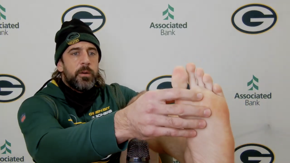 Aaron Rodgers shows off his fractured toe to media.