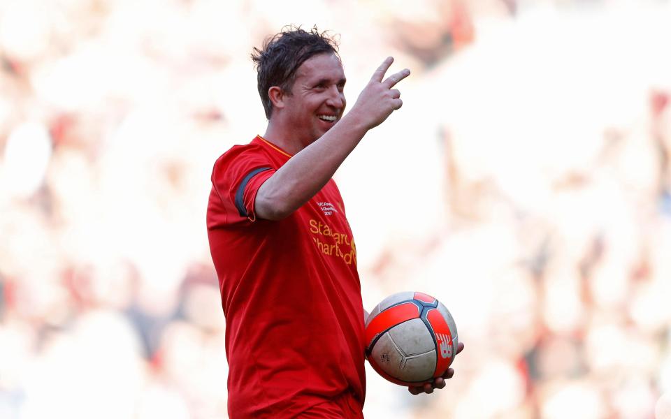 Liverpool's Robbie Fowler gestures towards the Kop End - Credit: REUTERS