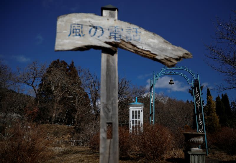The Wider Image: Japan's tsunami survivors call lost loves on the phone of the wind