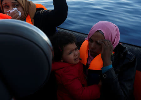 Migrants react after being rescued by the Malta-based NGO Migrant Offshore Aid Station (MOAS) from a wooden boat in the central Mediterranean in international waters off the coast of Sabratha in Libya, April 15, 2017. REUTERS/Darrin Zammit Lupi