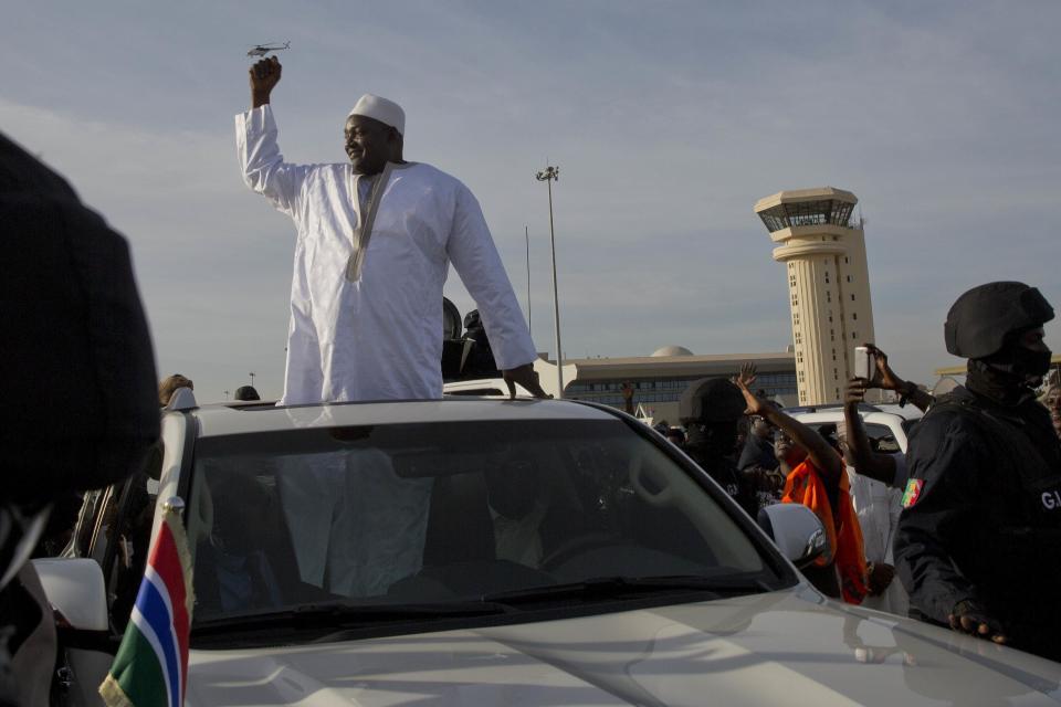 Gambian President Adama Barrow greets the crowds after arriving at Banjul airport in Gambia, Thursday Jan. 26, 2017, after flying in from Dakar, Senegal Gambia's new president has finally arrived in the country, a week after taking the oath of office abroad amid a whirlwind political crisis. Here's a look at the tumble of events that led to Adama Barrow's return — and the exile of the country's longtime leader. (AP Photo/Jerome Delay)