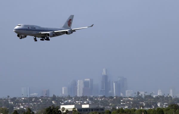 A 747 comes in for a landing at LAX with the downtown skyline as a backdrop. The best spots to watch planes? El Segundo's Imperial Hill area and next to the In-N-Out Burger on Sepulveda Boulevard.