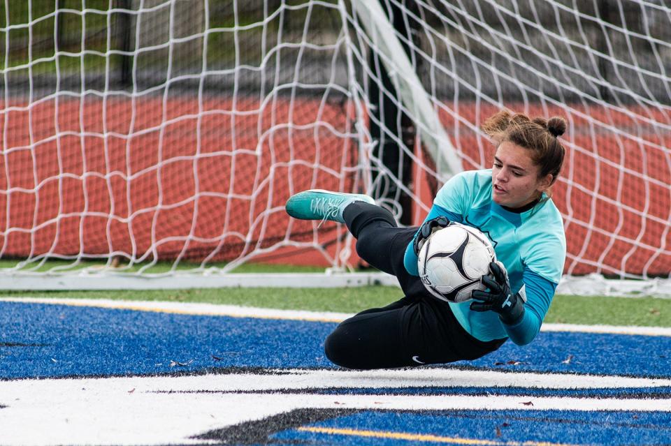 Arlington keeper Kayla Kalbaugh makes a diving save during the Class AAA girls soccer regional final against Monroe-Woodbury on Nov. 4, 2023.