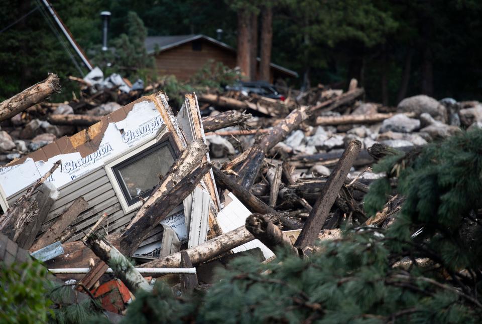 A debris field stretches along the banks of the Cache La Poudre River after flash flooding ripped through a drainage near Black Hollow Road in the Poudre Canyon near Rustic, Colo. on Wednesday, July 21, 2021. 