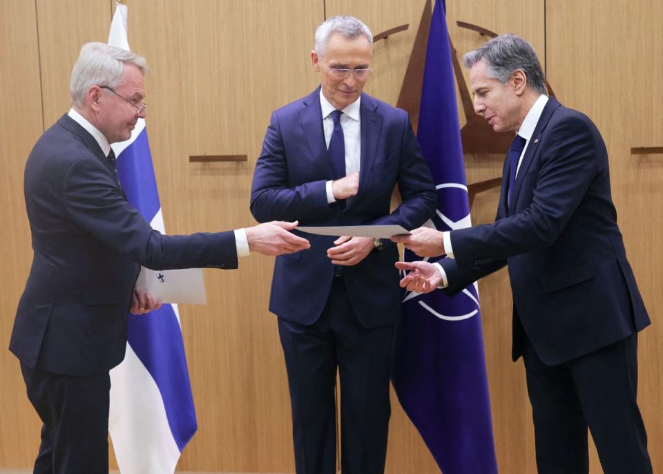 Finnish Foreign Affairs Minister Pekka Haavisto (L) hands over Finland’s accession to Nato documents to US Secretary of State Antony Blinken (POOL/AFP via Getty Images)