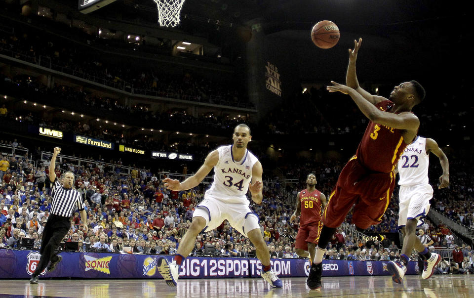 Iowa State's Melvin Ejim (3) shoots as he falls out of bounds during the second half of an NCAA college basketball game against Kansas in the semifinals of the Big 12 Conference tournament on Friday, March 14, 2014, in Kansas City, Mo. Iowa State won the game 94-83. (AP Photo/Charlie Riedel)