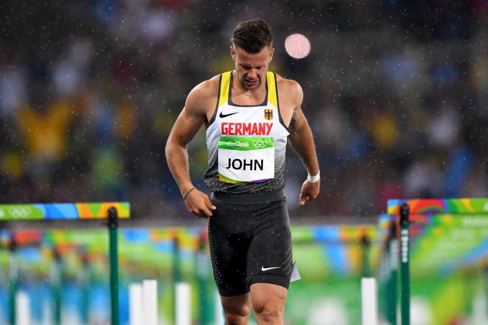 <p>Alexander John of Germany reacts after being disqualified as rain falls following the Men’s 110m Hurdles Round 1 – Heat 1 on Day 10 of the Rio 2016 Olympic Games at the Olympic Stadium on August 15, 2016 in Rio de Janeiro, Brazil. (Getty) </p>