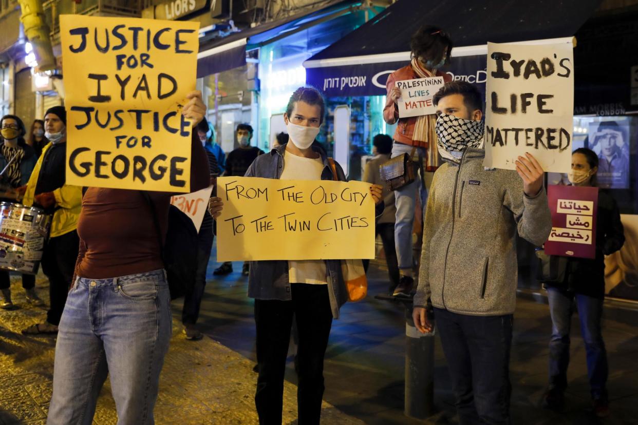 Israeli demonstrators carry placards during a demonstration condemning the shooting of Iyad Hallak, a disabled Palestinian man who was shot dead by Israeli police: Photo by AHMAD GHARABLI/AFP via Getty Images