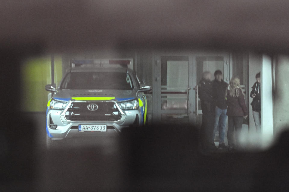 A police car, seen through the back window of a parked car, is stationed outside the F. D. Roosevelt University Hospital, where Slovak Prime Minister Robert Fico, who was shot and injured, is treated, in Banska Bystrica, central Slovakia, Friday, May 17, 2024. Fico, 59, was shot multiple times on Wednesday as he was greeting supporters after a government meeting in the former coal mining town of Handlova. Officials at first reported that doctors were fighting for his life but after a five-hour operation described his situation as serious but stable. (AP Photo/Denes Erdos)
