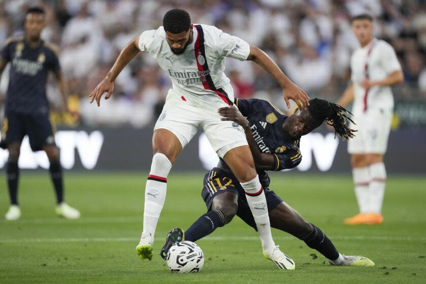 AC Milan midfielder Ruben Ira Loftus-Cheek (8) and Real Madrid FC midfielder Eduardo Camavinga (12) vie for the ball during the first half of a Soccer Champions Tour exhibition match, Sunday, July 23, 2023, in Pasadena, Calif. (AP Photo/Ashley Landis)