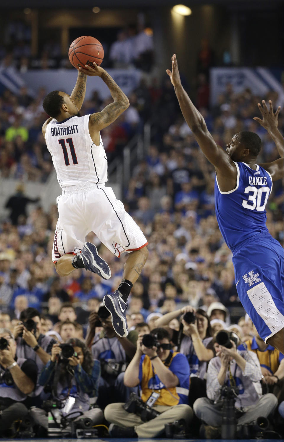 Connecticut guard Ryan Boatright, left, shoots over Kentucky forward Julius Randle during the second half of the NCAA Final Four tournament college basketball championship game Monday, April 7, 2014, in Arlington, Texas. (AP Photo/David J. Phillip)