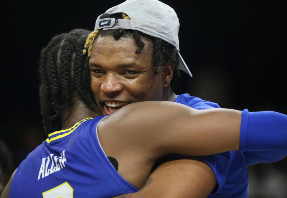 Delaware's Jyare Davis hugs teammate Ryan Allen after the Blue Hens won the Colonial Athletic Association championship 59-55 against UNCW at the Entertainment & Sports Arena in Washington, D.C., Tuesday, March 8, 2022.