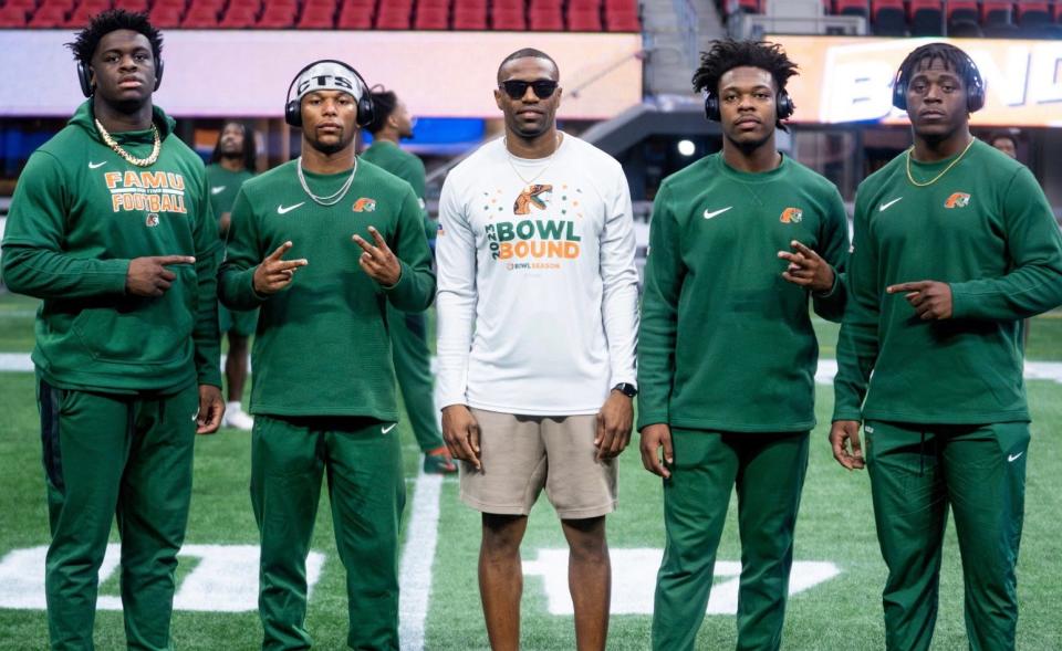 Florida A&M running backs coach Marcus Windham (middle) stands with his position group as the Rattlers practice a day before playing the Howard Bison in the HBCU Celebration Bowl at Mercedes-Benz Stadium in Atlanta, Georgia, Saturday, December 15, 2023.