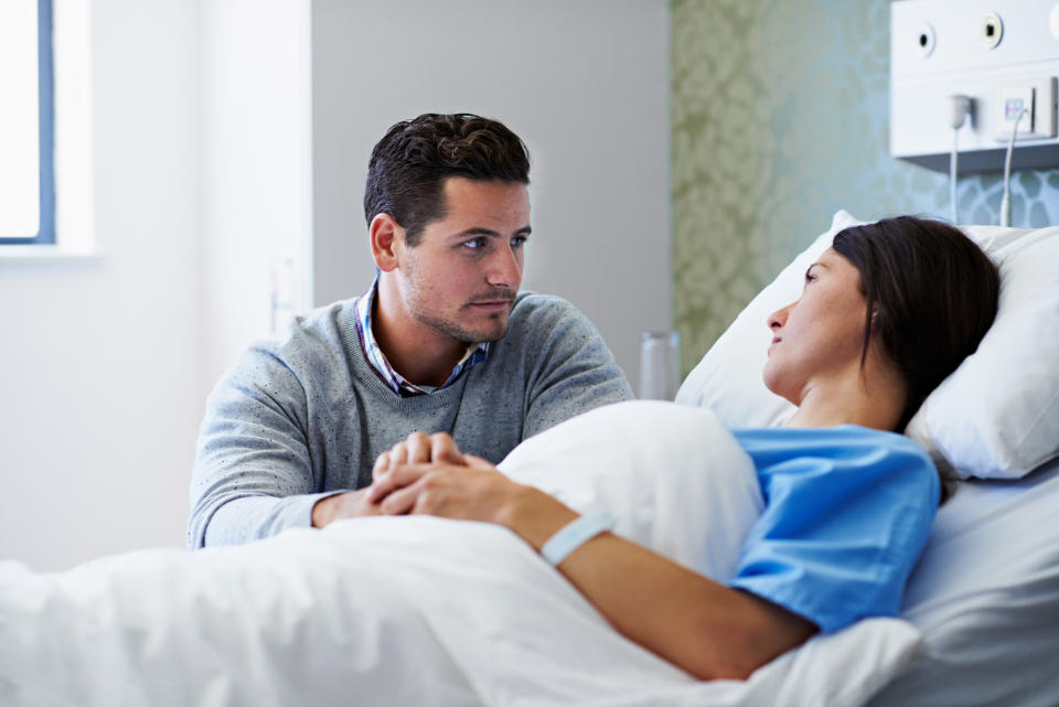 A man comforting his partner in the hospital