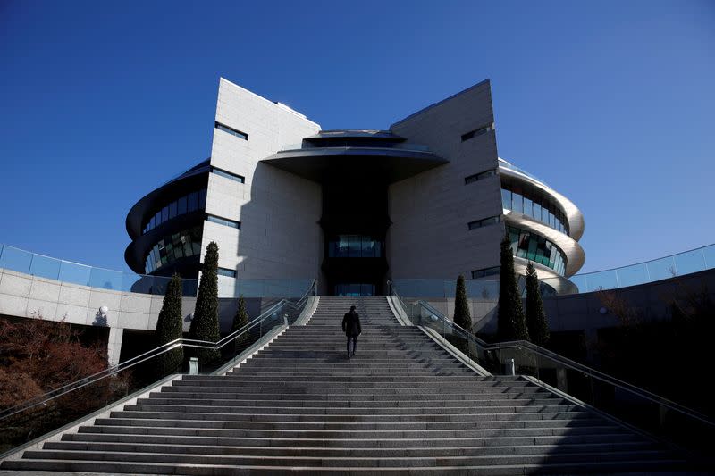 FILE PHOTO: A man walks up stairs at the eurozone's largest bank Santander's headquarters in Boadilla del Monte