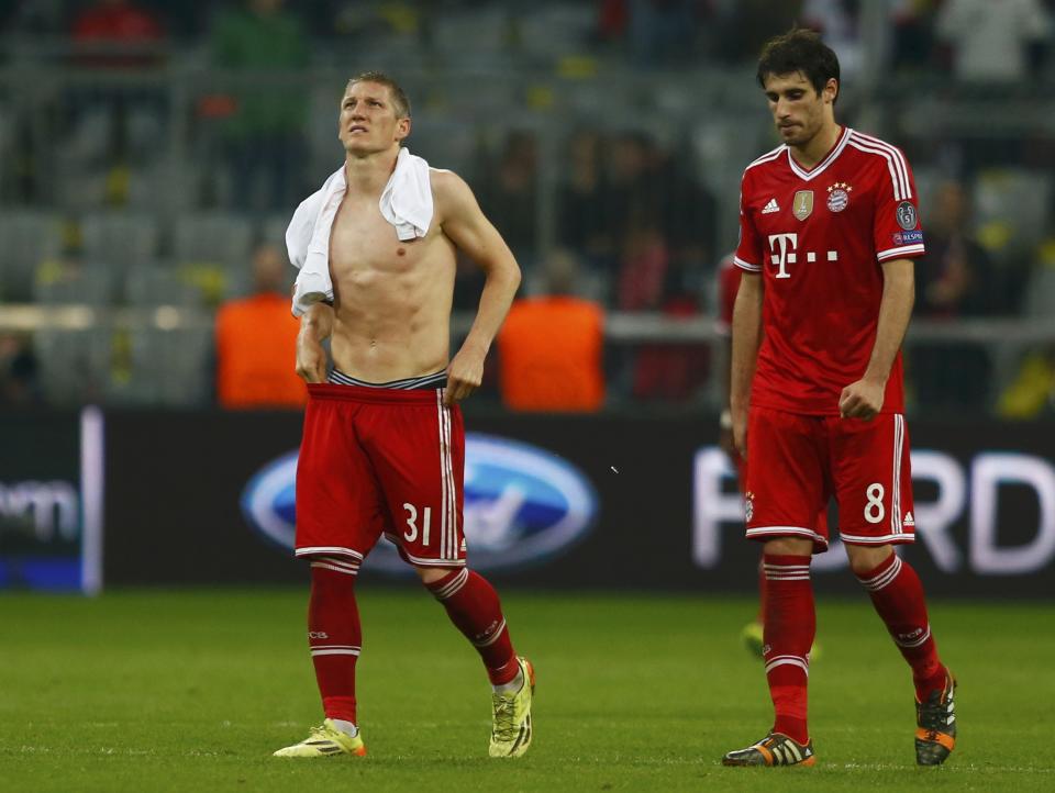 Bayern Munich's Schweinsteiger and Martinez walk off the pitch after losing their Champions League semi-final second leg soccer match against Real Madrid in Munich