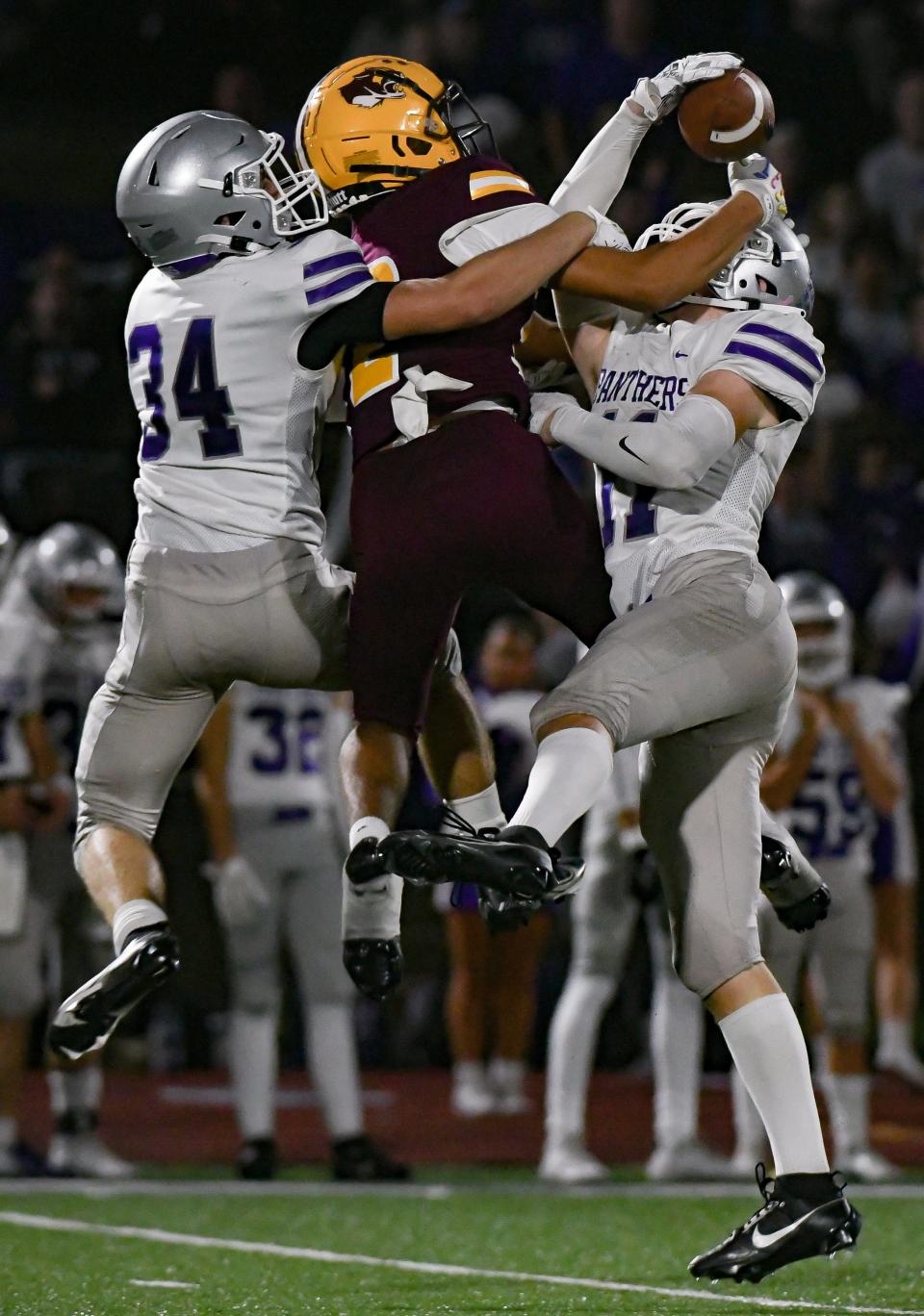 Bloomington South’s Evan Roudebush (34) and Miles McKay (11) break up a pass intended for Bloomington North’s Jorian Brooks (12) during the IHSAA sectional semi-final football game at Bloomington North on Friday, Oct. 27, 2023.