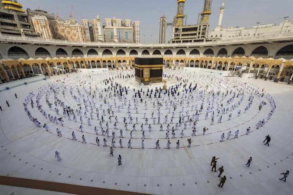 Pilgrims walk around the Kabba at the Grand Mosque, in the Muslim holy city of Mecca, Saudi Arabia, Friday, July 31, 2020. The global coronavirus pandemic has cast a shadow over every aspect of this year's pilgrimage, which last year drew 2.5 million Muslims from across the world to Mount Arafat, where the Prophet Muhammad delivered his final sermon nearly 1,400 years ago. Only a very limited number of pilgrims were allowed to take part in the hajj amid numerous restrictions to limit the potential spread of the coronavirus. (Saudi Ministry of Media via AP)