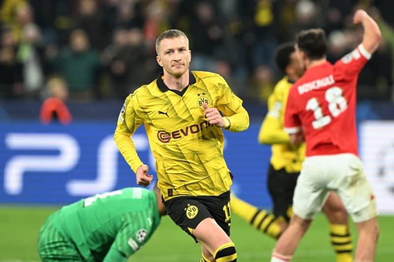 Borussia Dortmund's Marco Reus (C) celebrates his side's second goal of the game during the UEFA Champions League Round of 16, second leg soccer match between Borussia Dortmund and PSV Eindhoven at Signal Iduna Park. Federico Gambarini/dpa