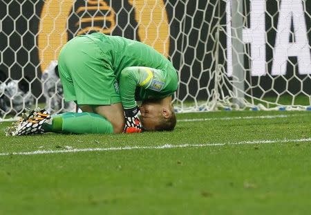 Goalkeeper Jasper Cillessen of the Netherlands reacts after failing to save the decisive penalty kick by Argentina's Maxi Rodriguez during the penalty shootout in their 2014 World Cup semi-finals at the Corinthians arena in Sao Paulo July 9, 2014. REUTERS/Darren Staples