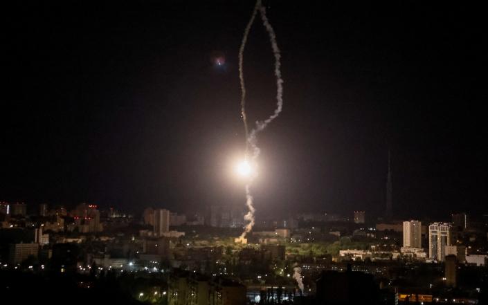 Explosion of a missile is seen in the sky over the city during a Russian missile strike - GLEB GARANICH/REUTERS