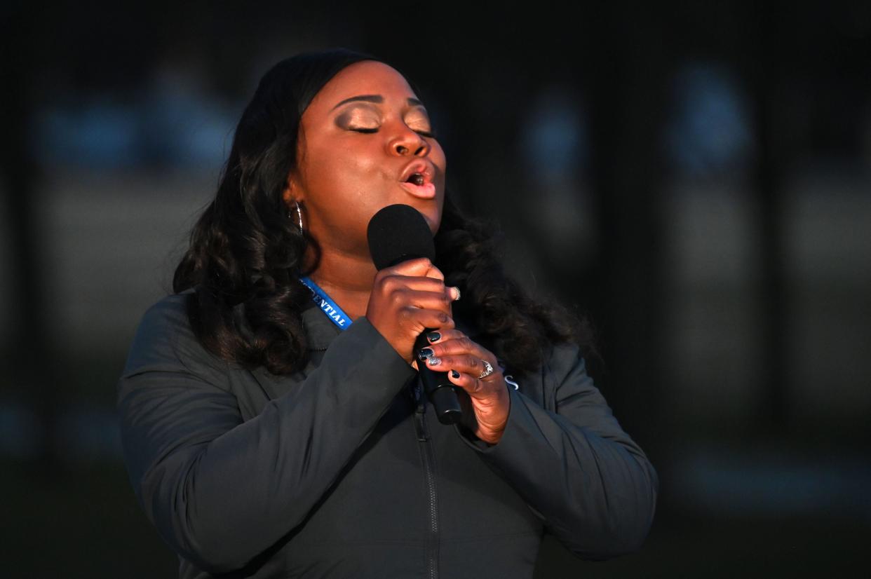 <p>Covid nurse Lori Marie Key sings ‘Amazing Grace’ at Covid-19 memorial on inauguration eve</p> (Getty Images)