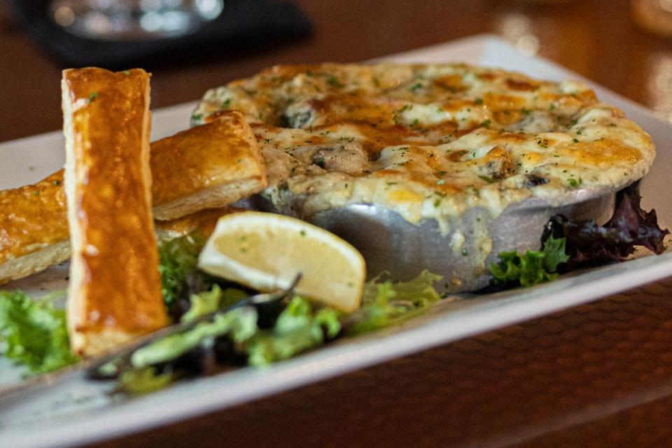 Fin & Flame Grill and Oyster Bar in Palm City features baked escargot pockets with a button mushroom cap and house-made roasted pepper compound butter, topped with melted mozzarella cheese and fresh-baked puff pastry breadsticks.