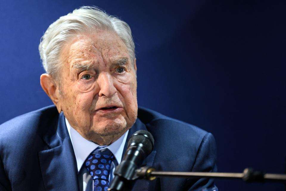 The nonagenarian George Soros at the microphone.