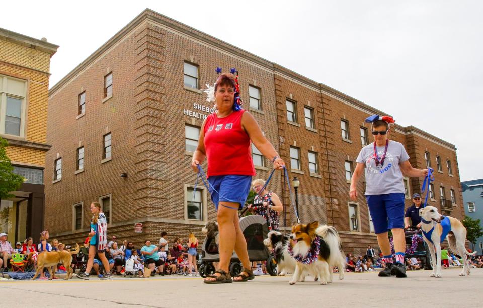 Members of the Sheboygan Dog Training club walk their canines during the Fourth of July parade.