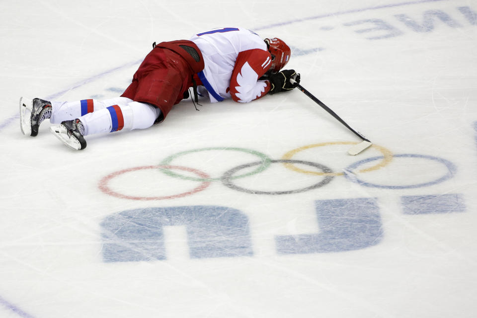 Russia forward Yevgeni Malkin lies on the ice in the closing minutes of the third period in men's quarterfinal hockey game against Finland at Bolshoy Arena at the 2014 Winter Olympics, Wednesday, Feb. 19, 2014, in Sochi, Russia. Finland defeated Russia 3-1. (AP Photo/David J. Phillip )