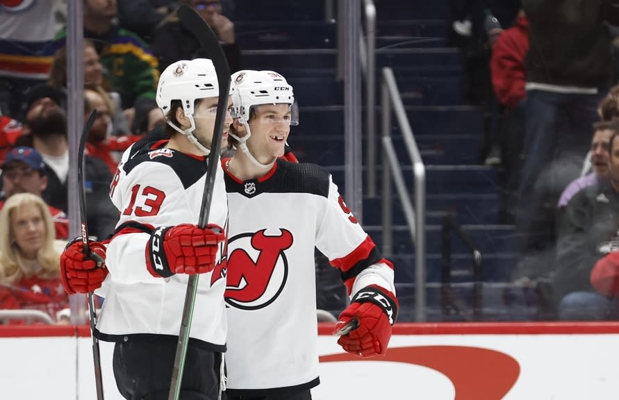 New Jersey Devils center Dawson Mercer (91) celebrates with Devils center Nico Hischier (13) after scoring a goal against the Washington Capitals in the second period at Capital One Arena.