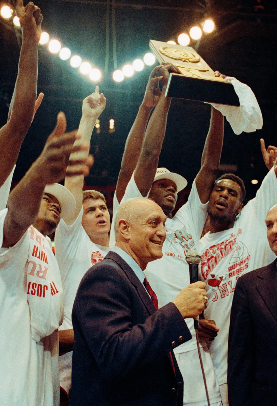 With their NCAA trophy in hand, UNLV coach Jerry Tarkanian and his players celebrate their Final Four victory over the Duke Blue Devils Monday 103-73. It was the largest margin of victory of any Final Four Championship game on April 3, 1990, in Denver.