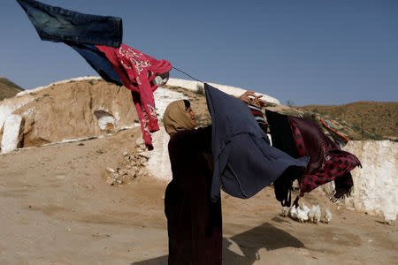 Saliha Mohamedi, 36, hangs washing at her troglodyte house on the outskirts of Matmata, Tunisia, February 5, 2018. "I don't want to leave my house, it would be as if I was throwing my life and my traditions away." Saliha said. REUTERS/Zohra Bensemra