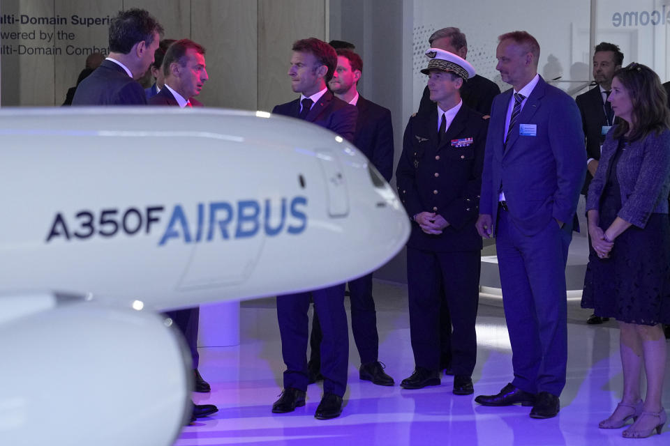 French President Emmanuel Macron, center left, listens to Airbus CEO Guillaume Faury, second left, as he visit the Airbus chalet at the International Paris Air Show, Monday, June 19, 2023 in Le Bourget, north of Paris. Aviation industry CEOs and top government officials from around the world descended on the Paris Air Show on Monday for a week of deal-making and demonstrations of the world's latest air and space technology (AP Photo/Michel Euler, Pool)
