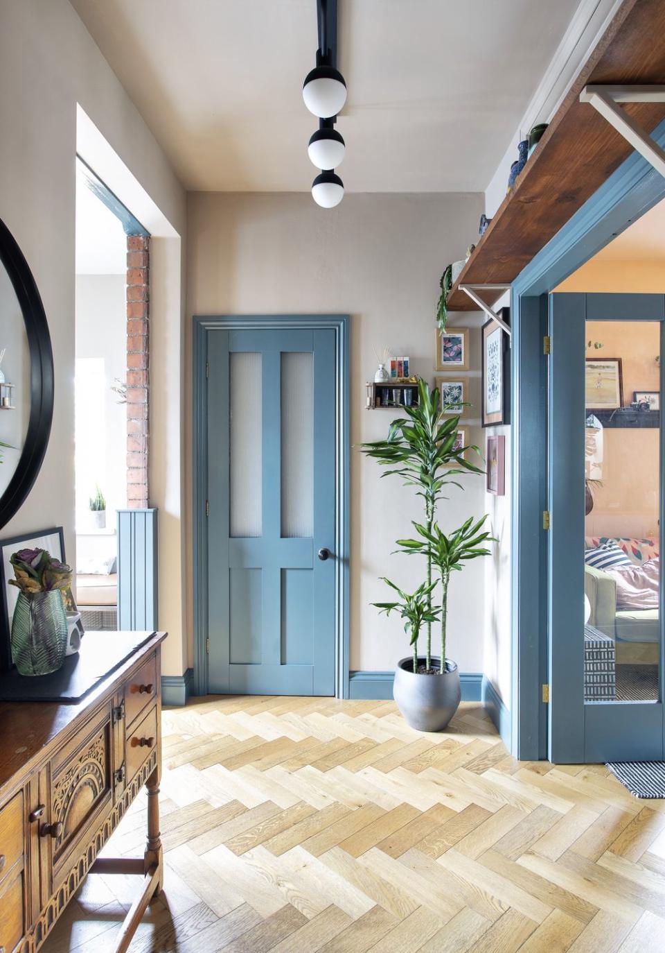 entrance hall with parquet flooring and blue painted door frames