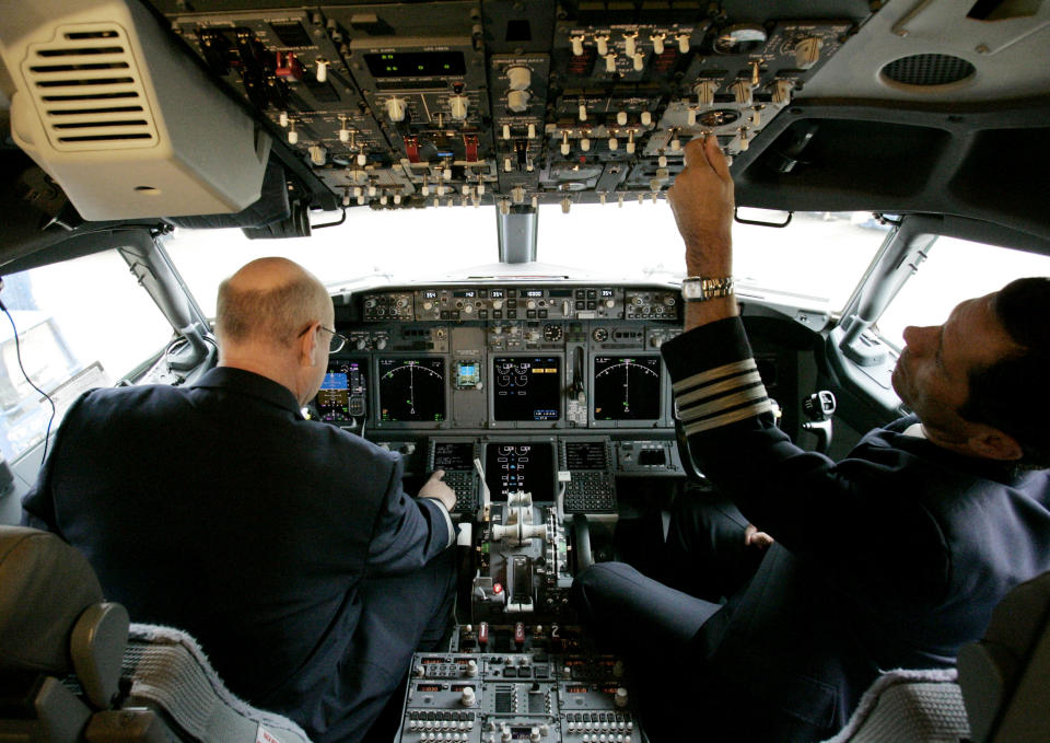 FILE - In this April 13, 2009, American Airlines Fleet Capt. Jim Kaiser, left, and Capt. Jim Thomas show the cockpit during a media preview of the newest addition to its fleet, Boeing 737-800 jets at Dallas Fort Worth International Airport in Grapevine, Texas. Boeing Co., the world's second-largest plane maker, said Wednesday, April 22, 2009, its first-quarter profit dropped by half, partly because of planned production cuts as airlines postpone deliveries of new planes. (AP Photo/Donna McWilliam, file)