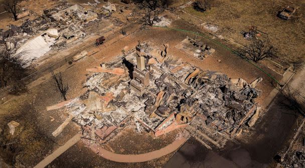 PHOTO: In this Sept. 24, 2021, file photo a burned residence is shown in Greenville, Calif. The Dixie fire has burned almost 1 million acres and remains at 94% containment after burning through 5 counties and more than 1,000 homes. (Josh Edelson/AFP via Getty Images, FILE)