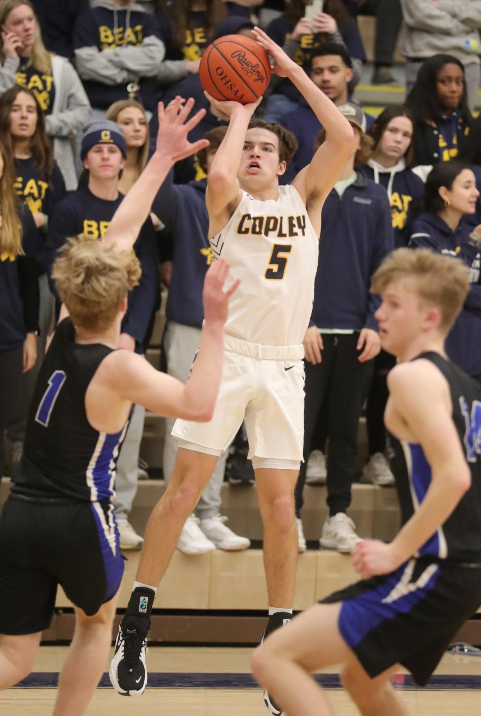 Copley's Trent Wininger puts up a 3-point shot between Revere's Chris Muntean, left, and Baron Bania on Tuesday, Feb. 8, 2022 in Copley.