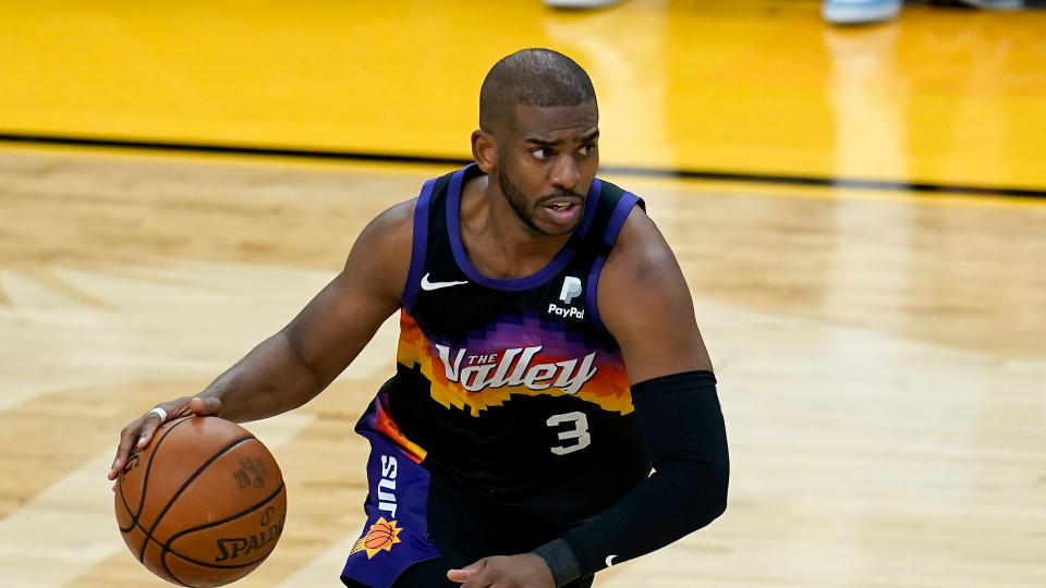 Phoenix Suns guard Chris Paul dribbles the ball against the Milwaukee Bucks during the second half of Game 2 of basketball's NBA Finals, Thursday, July 8, 2021, in Phoenix. The Suns defeated the Bucks 118-108. (AP Photo/Ross D. Franklin)