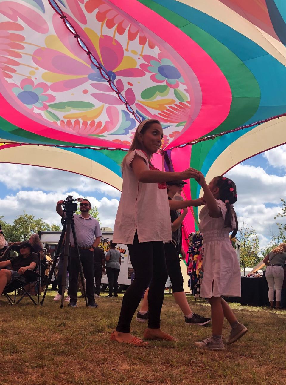 Irais Ferreira and her daughter, Mia, 5, dance to Latin music on Saturday, Sept. 9, 2023, at Fusion Fest at Howard Park in South Bend.