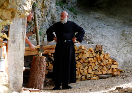 Hermit Stan Vanuytrecht of Belgium talks to a worker outside his hermitage in Saalfelden, Austria, May 22, 2017. Picture taken May 22, 2017. REUTERS/Leonhard Foeger