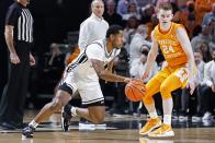 Vanderbilt forward Jordan Wright (4) drives against Tennessee guard Justin Powell (24) during the first half of an NCAA college basketball game Tuesday, Jan. 18, 2022, in Nashville, Tenn. (AP Photo/Wade Payne)